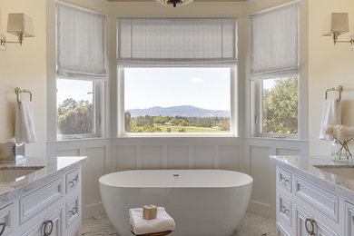 Inspiration for a large country master bathroom in San Francisco with beaded inset cabinets, white cabinets, a freestanding tub, stone tile, yellow walls, mosaic tile floors, an undermount sink, marble benchtops, white floor, a hinged shower door and an alcove shower.