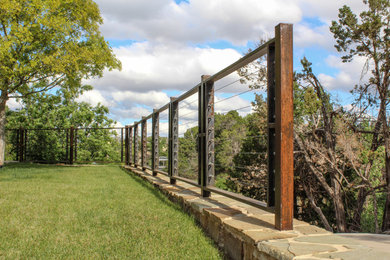 Photo of a mid-sized rustic full sun side yard stone retaining wall landscape in Austin for summer.