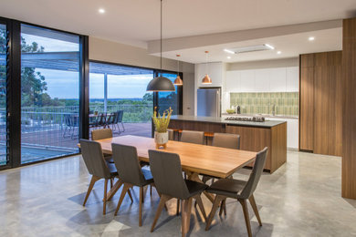 Photo of a contemporary open plan dining in Perth with beige walls, concrete floors and grey floor.