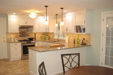 Inspiration for a small timeless u-shaped ceramic tile and beige floor eat-in kitchen remodel in Boston with a double-bowl sink, raised-panel cabinets, white cabinets, granite countertops, beige backsplash, ceramic backsplash, stainless steel appliances and a peninsula