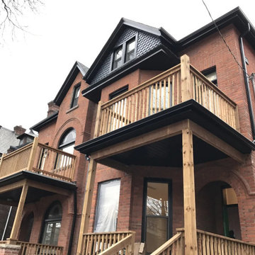 New upper and lower porch decks on a pair of heritage brick units, Etobicoke