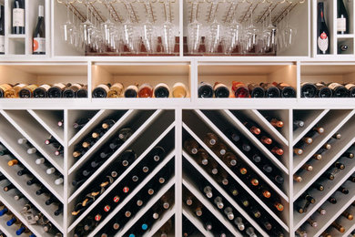 Design ideas for an expansive classic wine cellar in Portland with medium hardwood flooring, storage racks and brown floors.