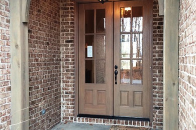 This is an example of a mid-sized traditional front door in Other with a double front door and a brown front door.