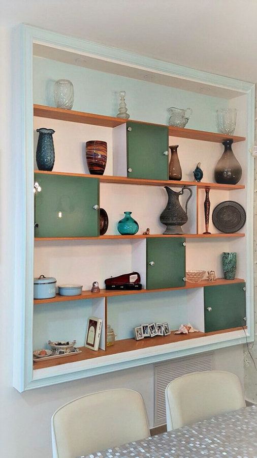close up of custom made built-in unit. Soft turquoise frame around it and glass