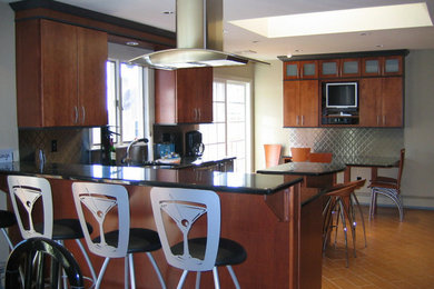 Mid-sized arts and crafts u-shaped ceramic tile eat-in kitchen photo in New York with a double-bowl sink, flat-panel cabinets, medium tone wood cabinets, granite countertops, gray backsplash, metal backsplash, stainless steel appliances and two islands
