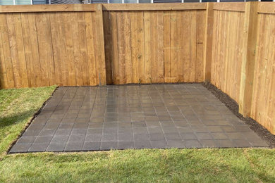 Design ideas for a small backyard stone landscaping in Edmonton.