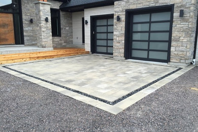 Garage - mid-sized contemporary attached two-car garage idea in Toronto