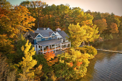 Inspiration for a timeless blue three-story concrete fiberboard exterior home remodel in Other with a shingle roof