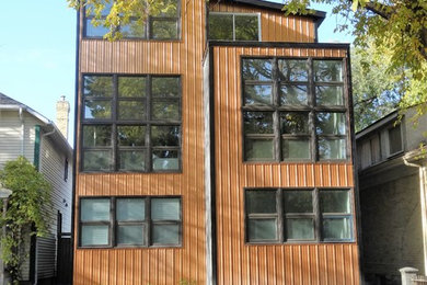 Mid-sized trendy brown three-story metal house exterior photo in Other with a shed roof