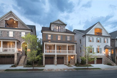 Large three-story brick exterior home idea in Atlanta