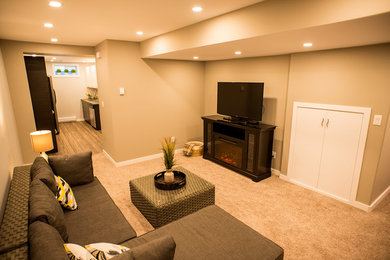 Inspiration for a large contemporary look-out carpeted and gray floor basement remodel in Other with gray walls and a standard fireplace