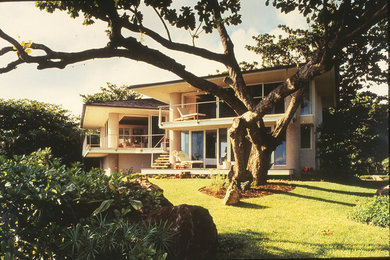 Example of a trendy beige two-story stucco exterior home design in Hawaii