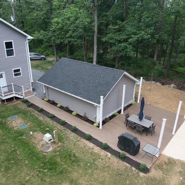 Elevated Tranquility: Deck Oasis with walkway, stairs and fire pit haven
