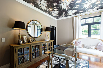Home office - mediterranean freestanding desk medium tone wood floor home office idea in Orange County with beige walls