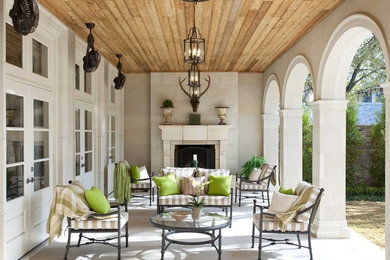 Example of a large classic side yard concrete paver patio design in Dallas with a fire pit and a roof extension