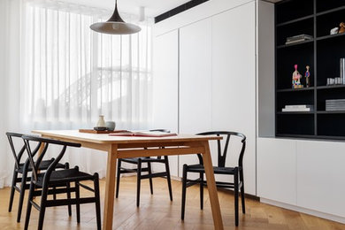 Inspiration for a small contemporary open plan dining in Sydney with white walls, medium hardwood floors and brown floor.