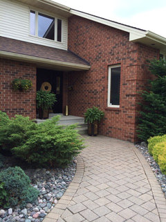 Colour Of Garage Doors With Glossy Black Trim On Red Brick House