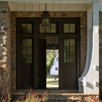 American Farmhouse Entry with Board and Batten and Rustic Stone