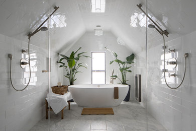 This is an example of a mid-sized contemporary master wet room bathroom in Denver with a freestanding tub, white tile, marble, white walls, porcelain floors and white floor.