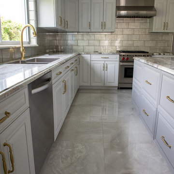Transitional Kitchen Done in a 2 Tone Color With Integrated Dining Table