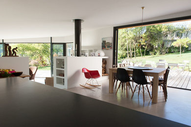 Inspiration for a large contemporary open plan dining in Lyon with white walls and concrete floors.