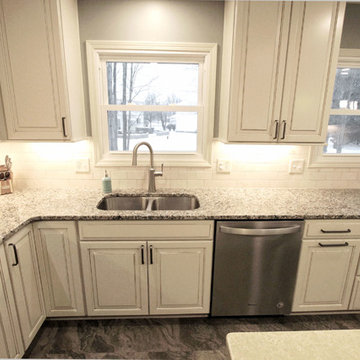 Beige Kitchen with Extra Large Island, Tile Backsplash and Granite Countertops