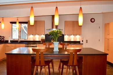 Open concept kitchen - large modern l-shaped slate floor and gray floor open concept kitchen idea in Philadelphia with an undermount sink, flat-panel cabinets, light wood cabinets, quartz countertops, stainless steel appliances, an island and black countertops