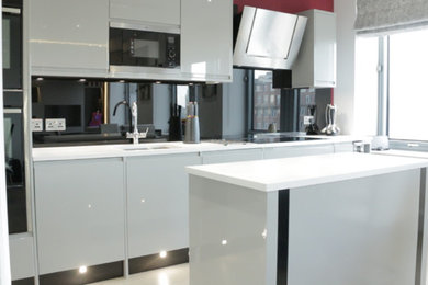 Photo of a small modern kitchen in London with with island.