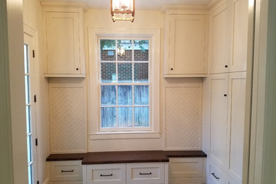 Entryway - large traditional medium tone wood floor and brown floor entryway idea in Charlotte with white walls and a white front door