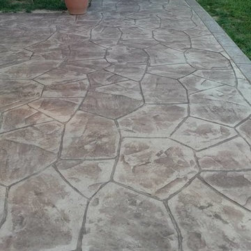 Stamped concrete patio with block seating wall and block fire-pit