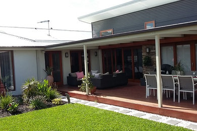 Mid-sized transitional side yard deck in Adelaide with a roof extension.