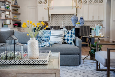 Inspiration for a huge eclectic open concept medium tone wood floor family room remodel in Phoenix with white walls, a standard fireplace, a brick fireplace and a wall-mounted tv