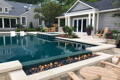 Inspiration for a large transitional backyard stone and rectangular pool house remodel in Kansas City