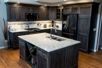 Mid-sized cottage l-shaped medium tone wood floor open concept kitchen photo in Calgary with a double-bowl sink, beaded inset cabinets, dark wood cabinets, granite countertops, white backsplash, porcelain backsplash, stainless steel appliances and an island