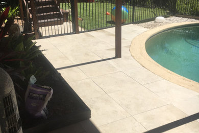 This is an example of a mid-sized modern backyard kidney-shaped pool in Sydney with tile.