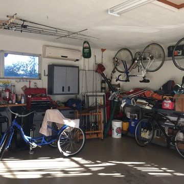 BEFORE: Cluttered garage filled with old bikes, cardboard boxes, fishing rods.