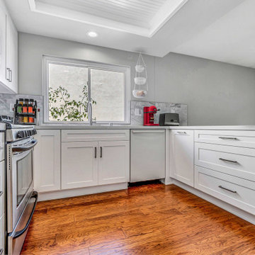 Bright Kitchen with Marble Backsplash and Quartz Surfaces