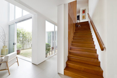 Mid-sized trendy wooden straight wood railing staircase photo in Other with wooden risers