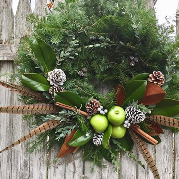 Wreath with green apples, magnolia leaves, pheasant feathers