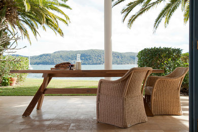 Design ideas for a large beach style backyard patio in Sydney.