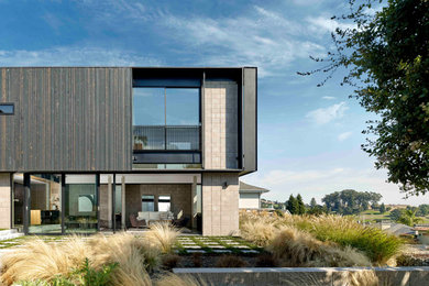 Large modern black two-story wood and board and batten exterior home idea in San Francisco