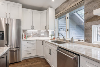 Large transitional l-shaped eat-in kitchen photo in Denver with an island