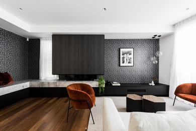 This is an example of an expansive contemporary living room in Brisbane with black walls, a two-sided fireplace and a stone fireplace surround.