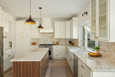 Example of a mid-sized transitional u-shaped light wood floor eat-in kitchen design in Austin with a farmhouse sink, shaker cabinets, white cabinets, marble countertops, beige backsplash, marble backsplash, stainless steel appliances, an island and beige countertops