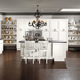 Large farmhouse kitchen pantry ideas - Example of a large farmhouse u-shaped kitchen pantry design in Stockholm with an island