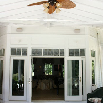 New porch with exposed rafters creates lovely outdoor entertaining area