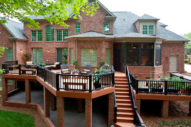 Expansive traditional backyard deck in Raleigh with no cover.