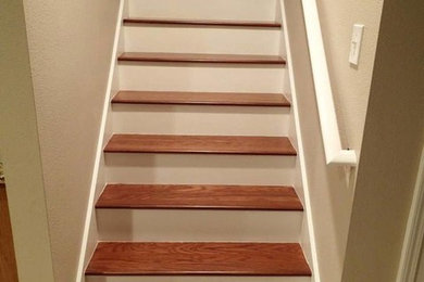 Mid-sized wooden l-shaped staircase photo in Tampa with painted risers