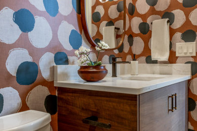Small transitional green tile porcelain tile, white floor and wallpaper powder room photo in Denver with flat-panel cabinets, dark wood cabinets, a two-piece toilet, an undermount sink, quartzite countertops, white countertops and a floating vanity