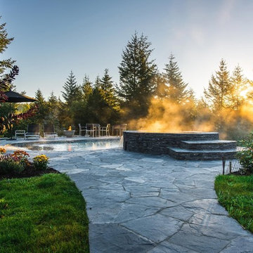 Vanishing Edge Concrete pool with spa and water feature